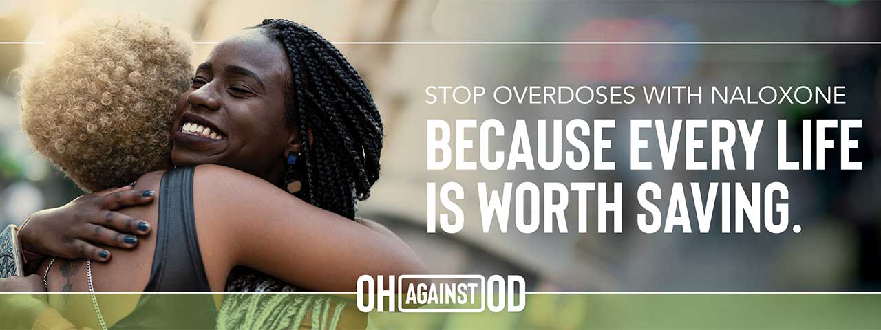 two women hugging with the text "Stop Overdoses with Naloxone Because every life is worth saving."